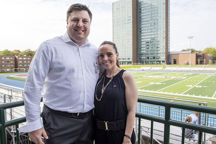 Alex Kyriacopulos with his partner at the sidelines of the Saint Mary's football field.