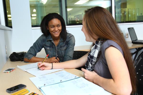 students talking at desk