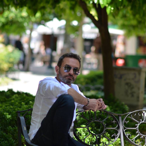 Seán Kennedy sitting, wearing sunglasses