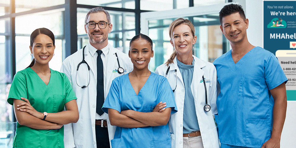 A group of medical staff in scrubs standing facing the camera.